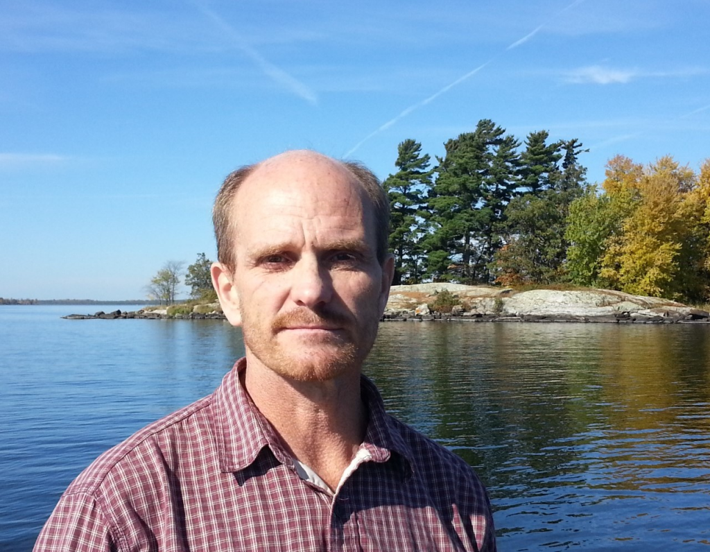 Photograph of Mark Ferrey by lake in the boundary waters canoe area