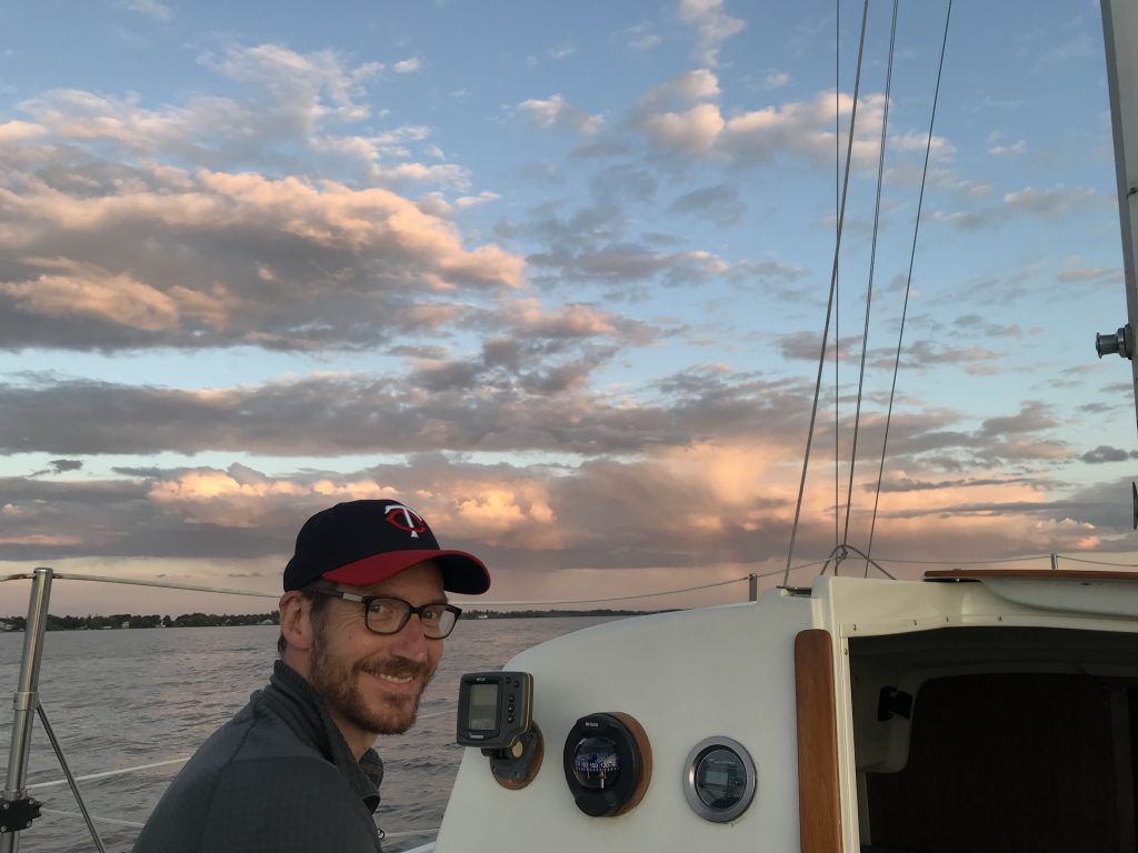 MGWA president, Jere Mohr, setting behind the steering wheel of a boat.