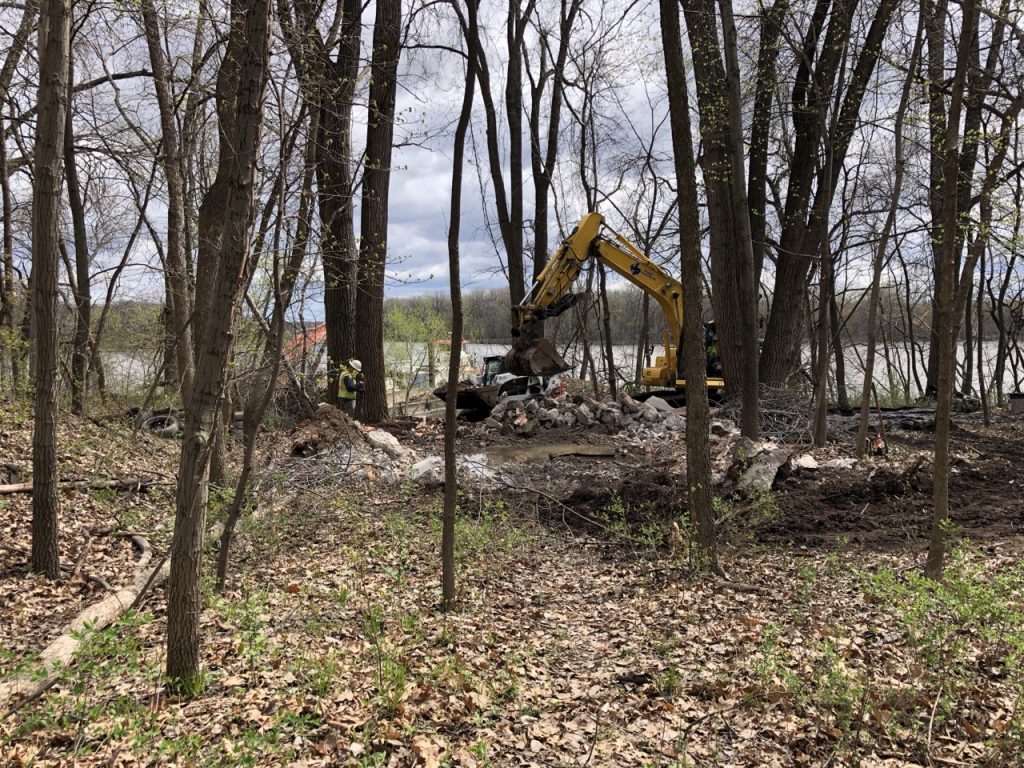 Photo of the demolished concrete structure. Since the site is an SNA, extra care was taken to limit the amount of trees removed during the project.