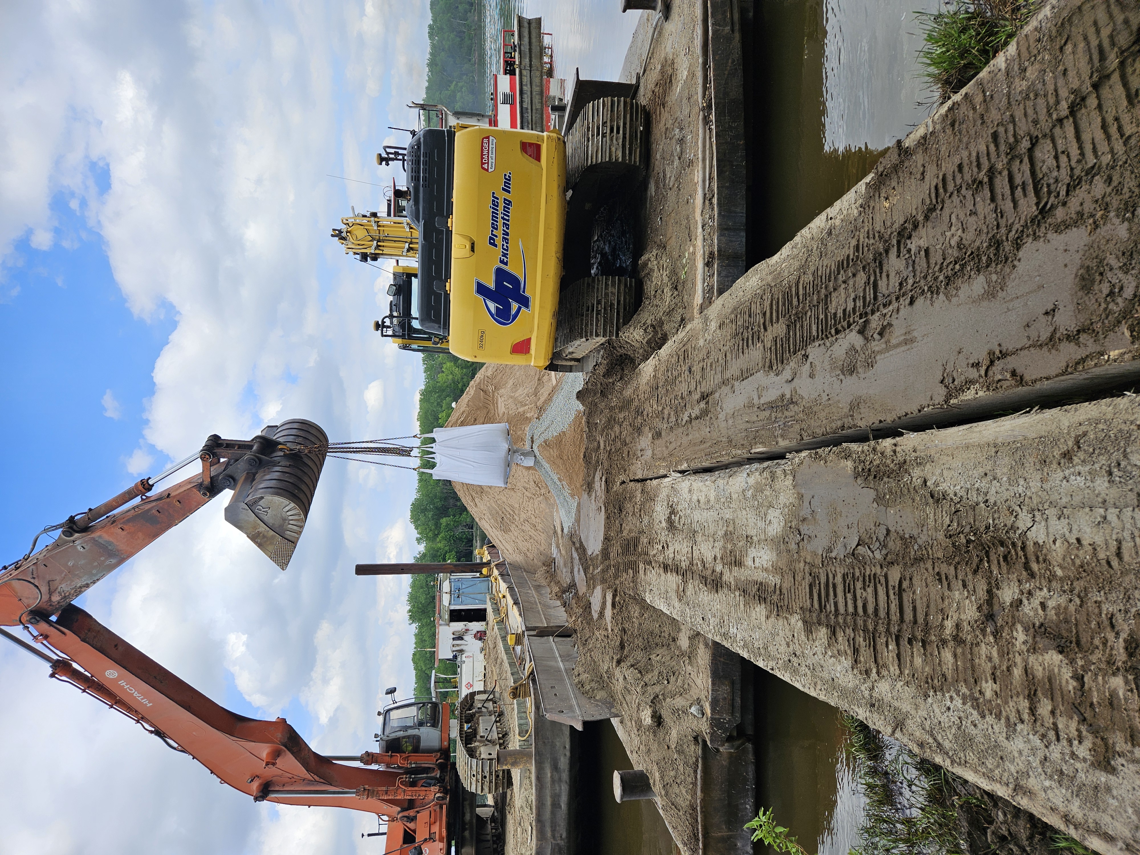 Photo of a super-sack of granular bentonite and sand getting mixed. They were mixed on the barge deck, then hauled up to the site and placed in the well.