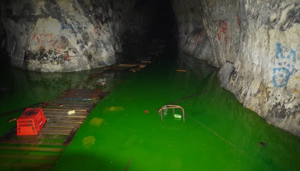 Photograph showing bright green water in a St. Paul cave.